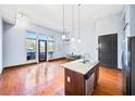 Open concept kitchen and living area with hardwood floors and island at 1195 Milton Se Ter # 2305, Atlanta, GA 30315