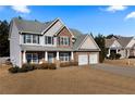 Two-story house with stone accents, two-car garage, and manicured lawn at 18 Ponders Se Rd, Cartersville, GA 30121