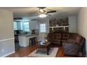 Living room with brown leather sectional and stone fireplace at 904 Little River Ln, Woodstock, GA 30189