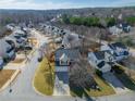 Aerial view of a residential neighborhood with houses and trees at 104 Holly Mill Village Dr, Canton, GA 30114