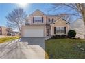 Two-story house with beige vinyl siding, a white garage door, and a well-maintained lawn at 104 Holly Mill Village Dr, Canton, GA 30114