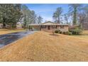 Ranch home with a paved driveway and yard at 1151 Mohican Trl, Stone Mountain, GA 30083