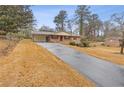 Ranch home with a long driveway and yard at 1151 Mohican Trl, Stone Mountain, GA 30083