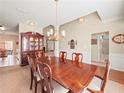 Formal dining room with a large wood table and hutch at 1843 Riverton Dr, Suwanee, GA 30024