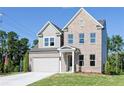 Two-story brick home with gray siding, attached garage, and landscaped lawn at 412 Newland Way, Acworth, GA 30102