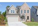 Two-story brick home with gray siding, attached garage, and landscaped lawn at 412 Newland Way, Acworth, GA 30102