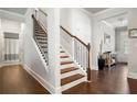 Elegant staircase with dark metal balusters and hardwood steps at 4568 Mantova Dr, Buford, GA 30519