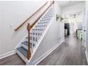 Modern staircase with gray steps and wood railing at 1495 Gabriel Dr, Lawrenceville, GA 30043