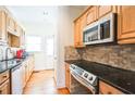 Bright kitchen featuring stainless steel appliances and light wood cabinets at 75 E Wesley Ne Rd # 4, Atlanta, GA 30306