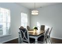 Bright dining room with a wood table and gray chairs at 5482 Fountainhead Ln, Auburn, GA 30011