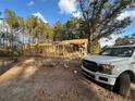 A partially constructed house with wooden frame, viewed from the front yard with a truck at 1386 Highway 92 S, Fayetteville, GA 30215
