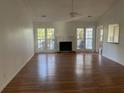 Bright living room with hardwood floors and a fireplace at 11564 Holly Ln, Hampton, GA 30228