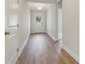 Inviting hallway with neutral walls, light wood floors and white trim at 405 Westmarch Cir, Loganville, GA 30052