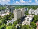 Stunning aerial view of a high-rise apartment complex surrounded by lush greenery and city skyline at 2479 Peachtree Ne Rd # 407, Atlanta, GA 30305