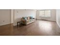 Spacious living room with hardwood floors, a comfortable couch, and bright natural light from the window at 2479 Peachtree Ne Rd # 407, Atlanta, GA 30305
