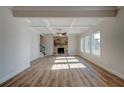 Spacious living room featuring hardwood floors and a cozy stone fireplace at 414 Westmarch Cir, Loganville, GA 30052