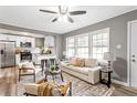 Bright living room with open layout, modern furniture, and kitchen view at 2745 Fairlane Se Dr, Atlanta, GA 30354