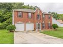 Two-story brick home, two-car garage, and lush green lawn at 4332 Abram Dr, Conley, GA 30288