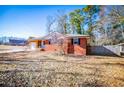 Brick ranch house with a fenced yard and attached garage at 6531 Temple St, Lithia Springs, GA 30122