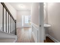 Entryway with staircase, wood floors, and a half bathroom at 7116 Fringe Flower Dr # 19, Austell, GA 30168