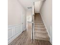 Bright hallway with hardwood flooring and a carpeted staircase at 7116 Fringe Flower Dr # 19, Austell, GA 30168