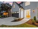 Front entrance with double doors and walkway leading to a dark gray garage at 2172 Briarlake Ne Trce, Atlanta, GA 30345