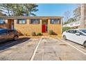 Brick townhouse with red front door and parking at 3318 Northcrest Rd # D, Atlanta, GA 30340