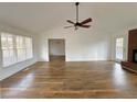 Open living room with hardwood floors, a brick fireplace, and neutral paint at 5409 Mill Valley Dr, Douglasville, GA 30135
