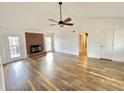 Spacious living room with hardwood floors, brick fireplace, and natural light at 5409 Mill Valley Dr, Douglasville, GA 30135