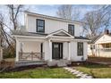 Charming two-story home with white siding, black framed windows, and a cozy front porch at 1449 Athens Sw Ave, Atlanta, GA 30310