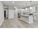 Modern kitchen features stainless steel appliances, a center island, and sleek gray cabinetry at 1449 Athens Sw Ave, Atlanta, GA 30310