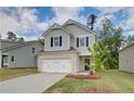 Charming two-story home featuring a brick-accented garage and manicured front lawn at 18 Camellia Dr, Fairburn, GA 30213