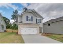 Charming two-story home featuring a brick-accented garage and manicured front lawn at 18 Camellia Dr, Fairburn, GA 30213