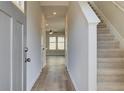 Bright entryway with hardwood floors and staircase leading upstairs at 20 Camellia Dr, Fairburn, GA 30213