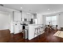 Modern kitchen with white cabinets, quartz countertops, stainless steel appliances, and a breakfast bar with seating at 840 Regal Ln, Atlanta, GA 30331
