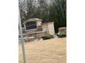 Stone monument sign for Creekstone community, surrounded by landscaping with grass in foreground at 11547 Hathaway Dr, Hampton, GA 30228