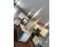 A bright kitchen with stainless steel appliances, granite counters, an island, and ample cabinet space at 11547 Hathaway Dr, Hampton, GA 30228