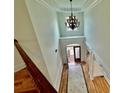 Two-story foyer with chandelier and hardwood floors at 1828 Austins Pointe Dr, Lawrenceville, GA 30043