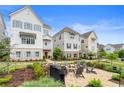 Charming two-story townhouse with a brick patio, fire pit, and cozy seating area in a beautifully landscaped yard at 396 Silverbell Way, Marietta, GA 30060