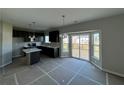 A new kitchen with stainless steel appliances, dark cabinetry, and an island for extra space at 110 Okeechobee Way, Braselton, GA 30548