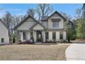 Two-story farmhouse with a welcoming porch and well-manicured lawn at 1679 Eastside Parc St, Atlanta, GA 30316