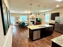 Open kitchen with island, stainless steel appliances, and granite countertops at 3909 Makeover Ct, Atlanta, GA 30349