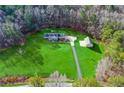 Expansive aerial view showcases lush green lawn and a charming home with additional outbuilding at 239 Cedar Ridge Dr, Dallas, GA 30157