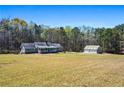 Quaint ranch-style home featuring a sprawling lawn and detached outbuilding for added space at 239 Cedar Ridge Dr, Dallas, GA 30157
