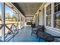 Relaxing covered porch with cozy seating, perfect for enjoying the serene outdoor view at 239 Cedar Ridge Dr, Dallas, GA 30157