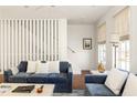 Living room with blue couches and white accents at 9057 Selborne Ln, Chattahoochee Hills, GA 30268