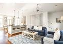 Open living space with kitchen and seating area at 9057 Selborne Ln, Chattahoochee Hills, GA 30268