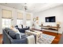 Spacious living room with hardwood floors and comfortable seating at 9057 Selborne Ln, Chattahoochee Hills, GA 30268
