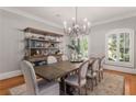 Elegant dining room with hardwood floors, large windows, and a beautiful chandelier at 4545 Whitestone Way, Suwanee, GA 30024