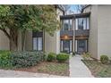 Tan colored exterior of a townhome with manicured landscaping and walkway at 16 Ivy Ne Rdg, Atlanta, GA 30342